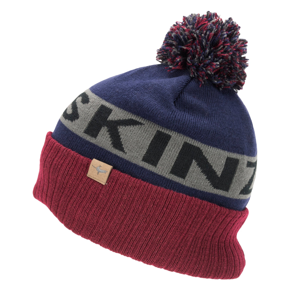 Navy knit bobble hat with burgundy cuff and grey stripe reading "SKI" plus leather logo patch
