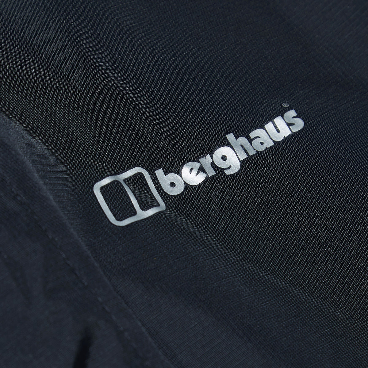 berghaus logo on dark waterproof overtrouser fabric