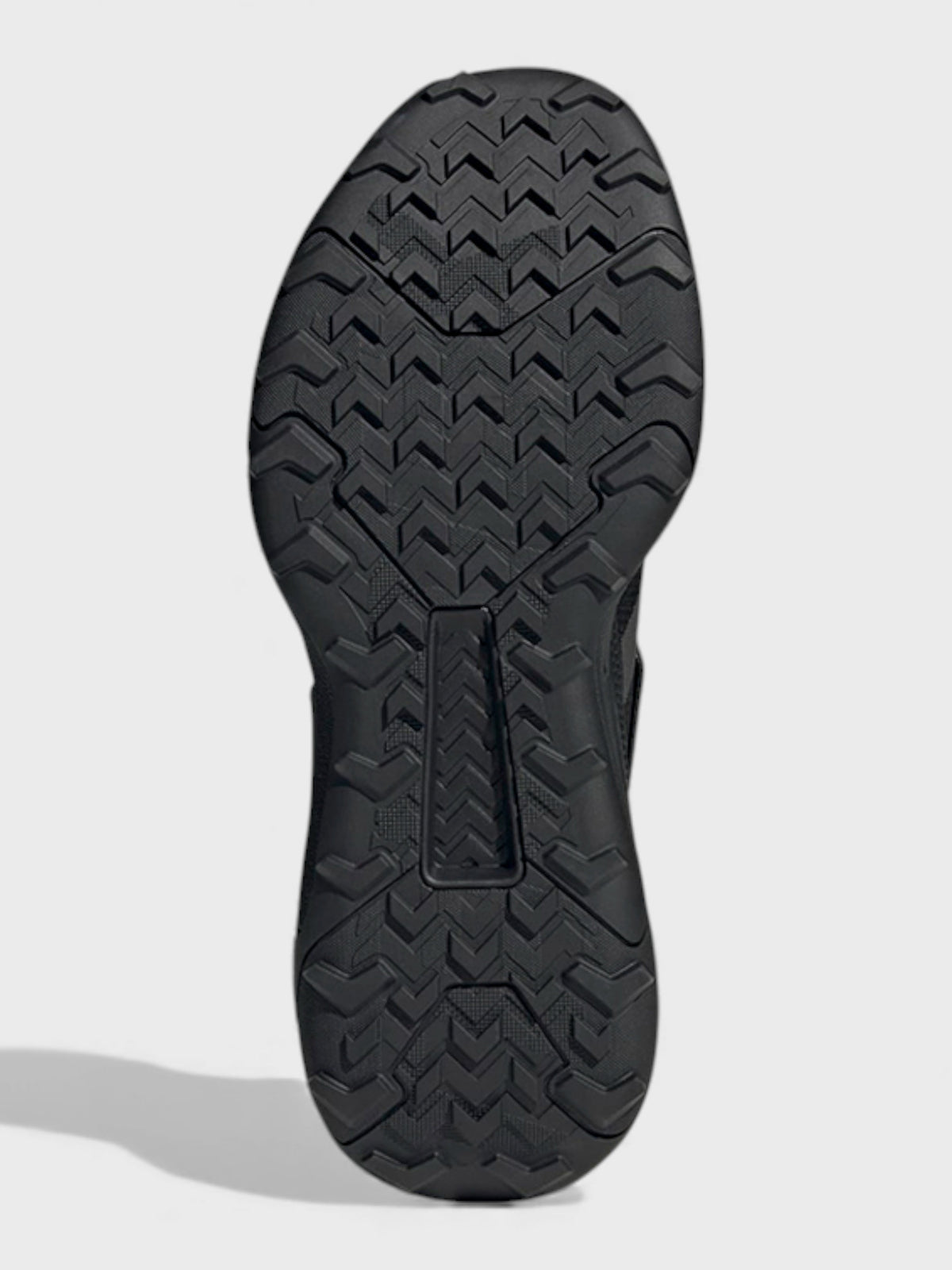 Black boot outsole tread with zigzag traction pattern and toe ridge