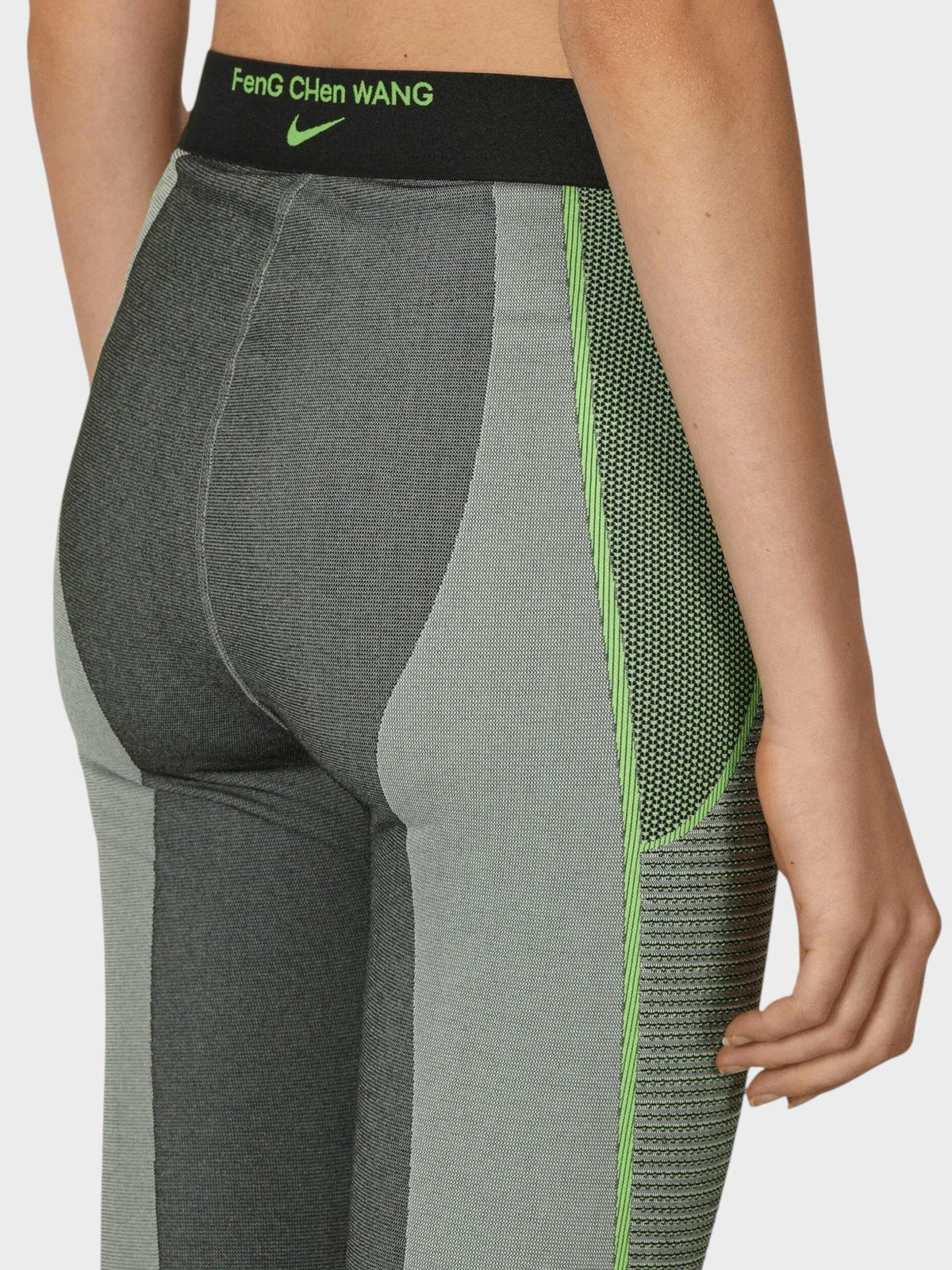 Women’s pro leggings with black waistband text and neon green textured side panel