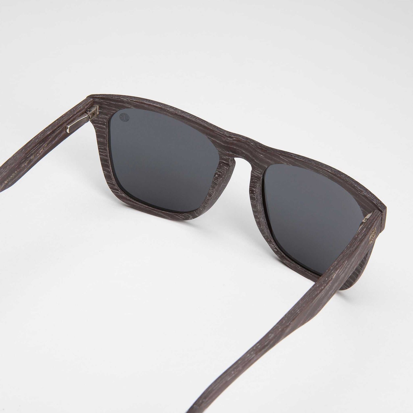 Polarized sunglasses, dark woodgrain frame and dark mirrored lenses.
