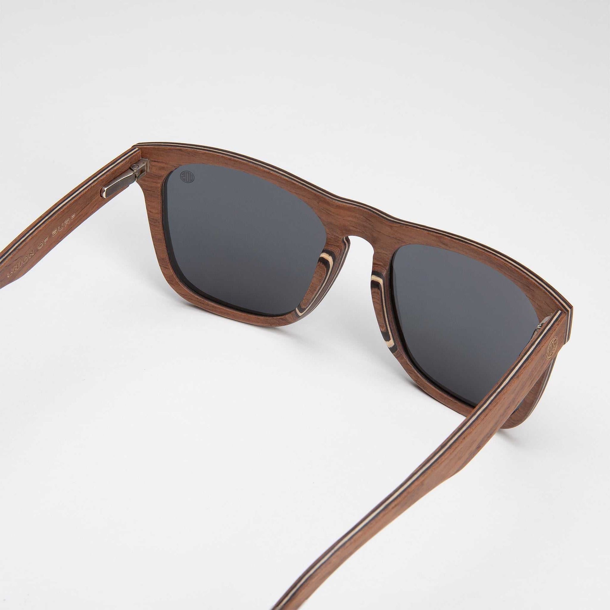Polarized sunglasses close-up with dark lenses and wood-tone acetate frame