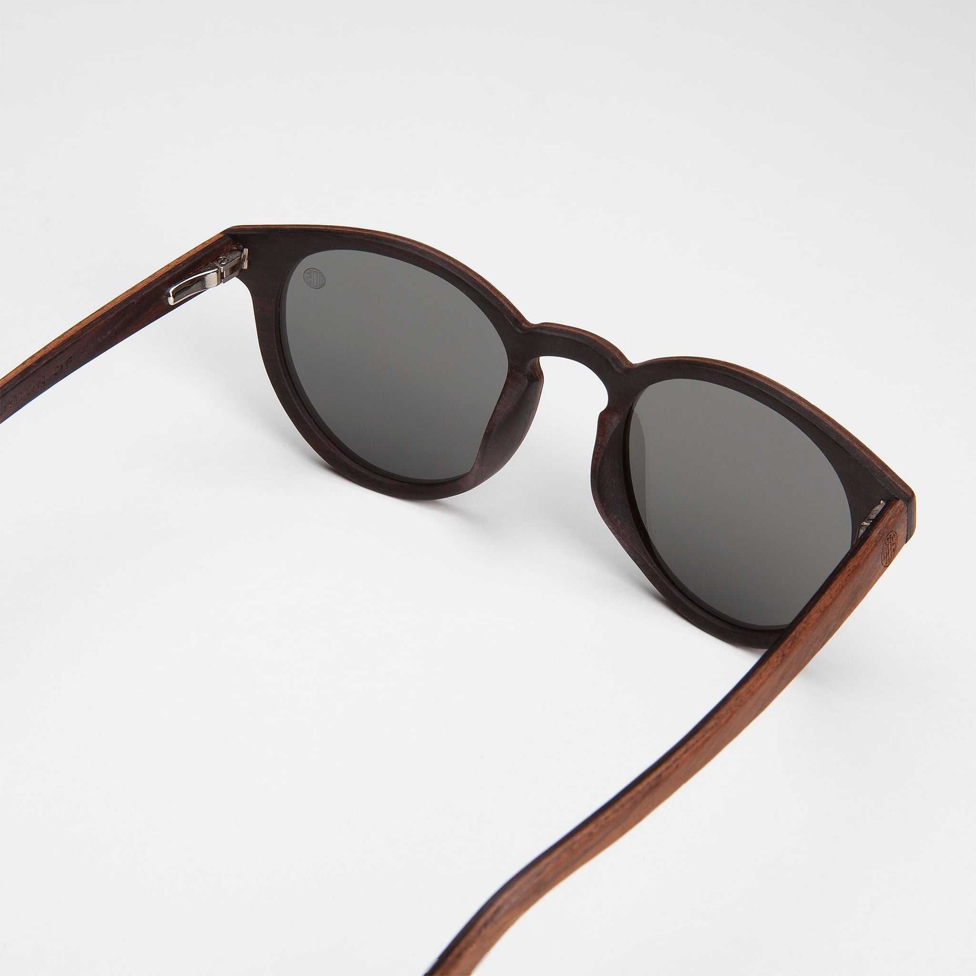 Dark-brown cat-eye sunglasses with mirrored silver lenses and hinge details