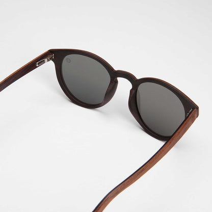 Dark-brown cat-eye sunglasses with mirrored silver lenses and hinge details