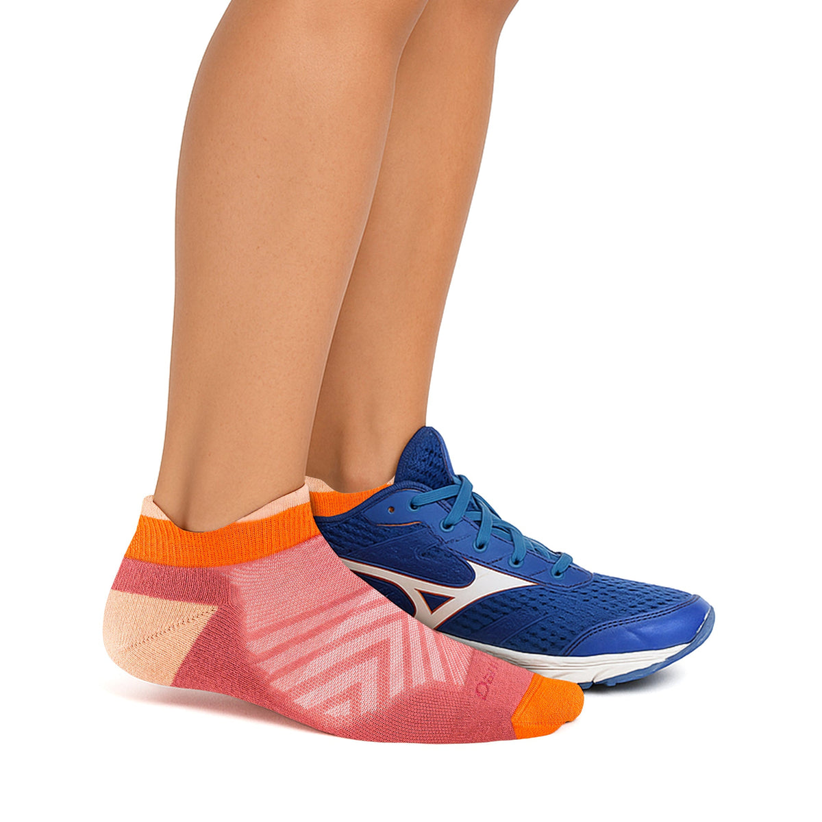 No-show merino running socks on foot, orange knit with geometric stripe pattern