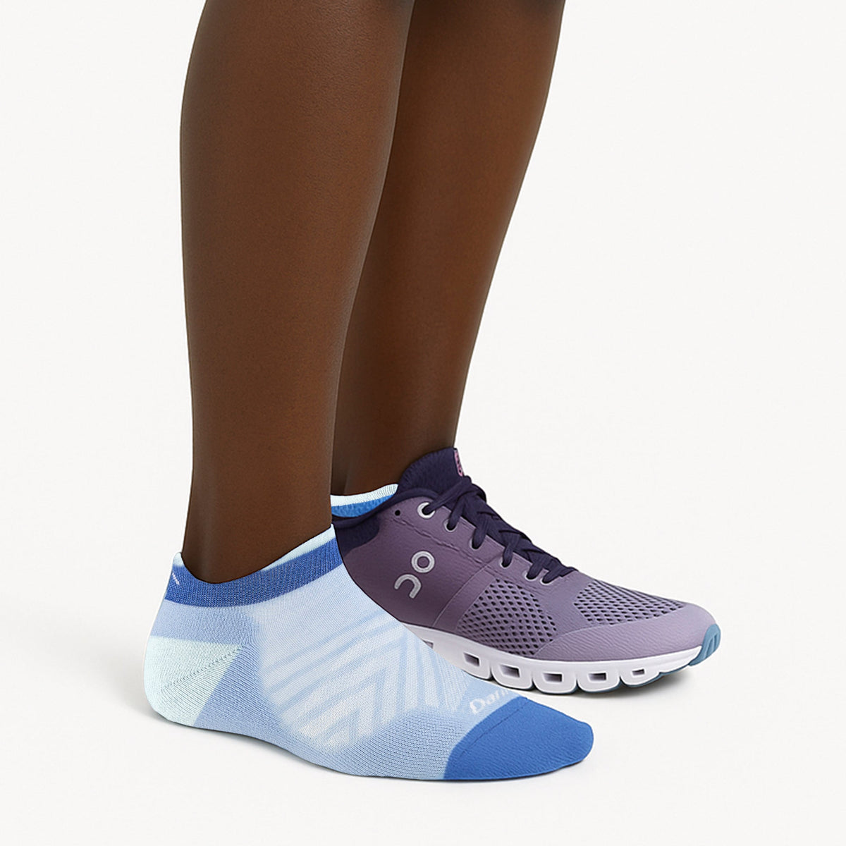 Purple and light blue no-show running socks with neon accents, worn with sneakers.