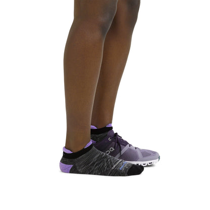 No-show running merino socks, charcoal with lavender trim on model’s feet