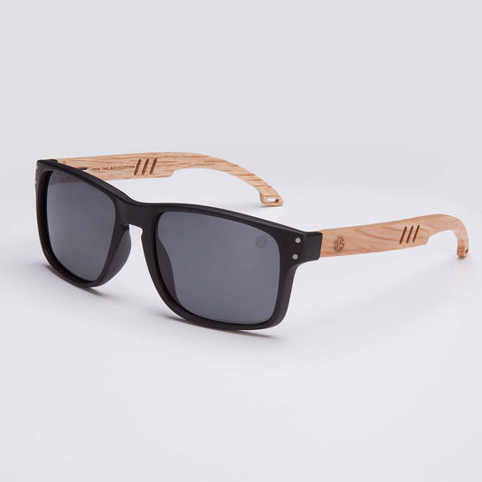 Men’s polarized sunglasses with real wood arms, black frames and dark lenses.