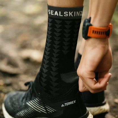 Black running socks with geometric pattern, mid-calf, SEAL SKINZ logo at cuff