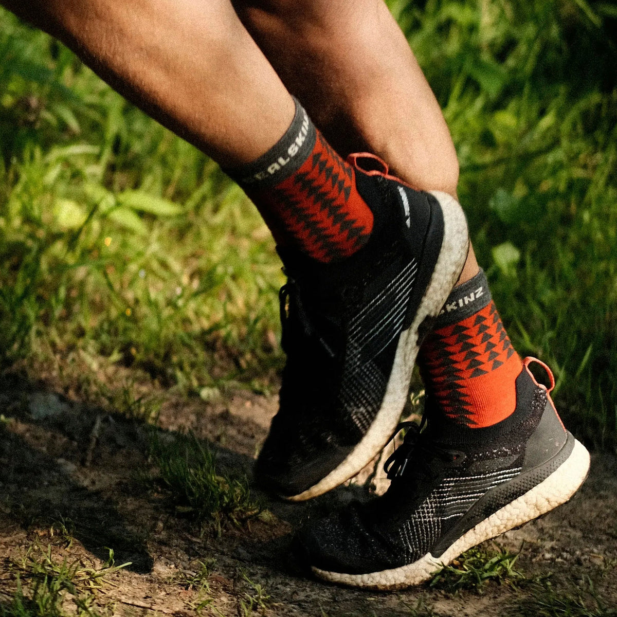 Orange and black running socks with geometric pattern, mid-calf, SEAL SKINZ on cuff