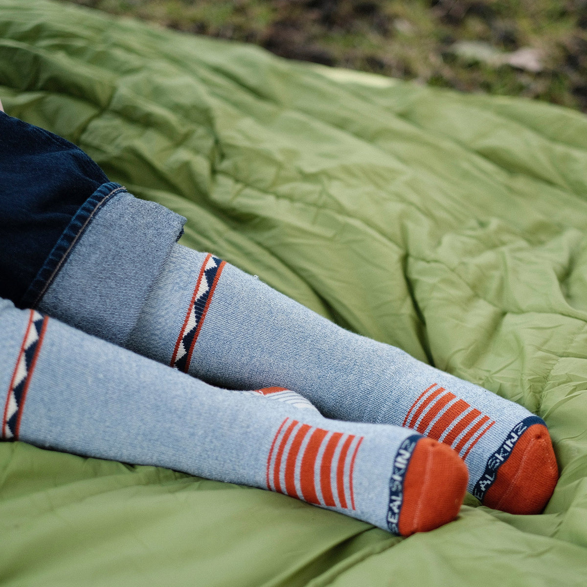 Orange and blue striped hiking socks on legs