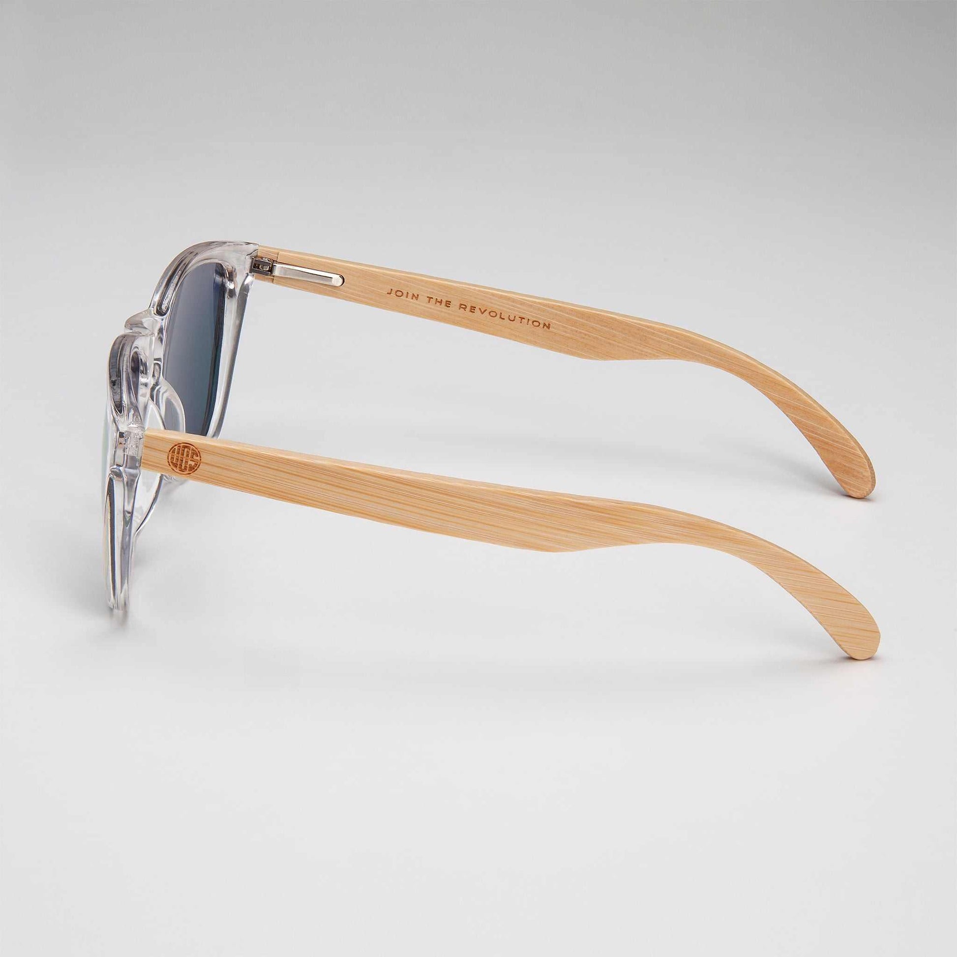 Side view of clear-framed polarised sunglasses with light wood temples.