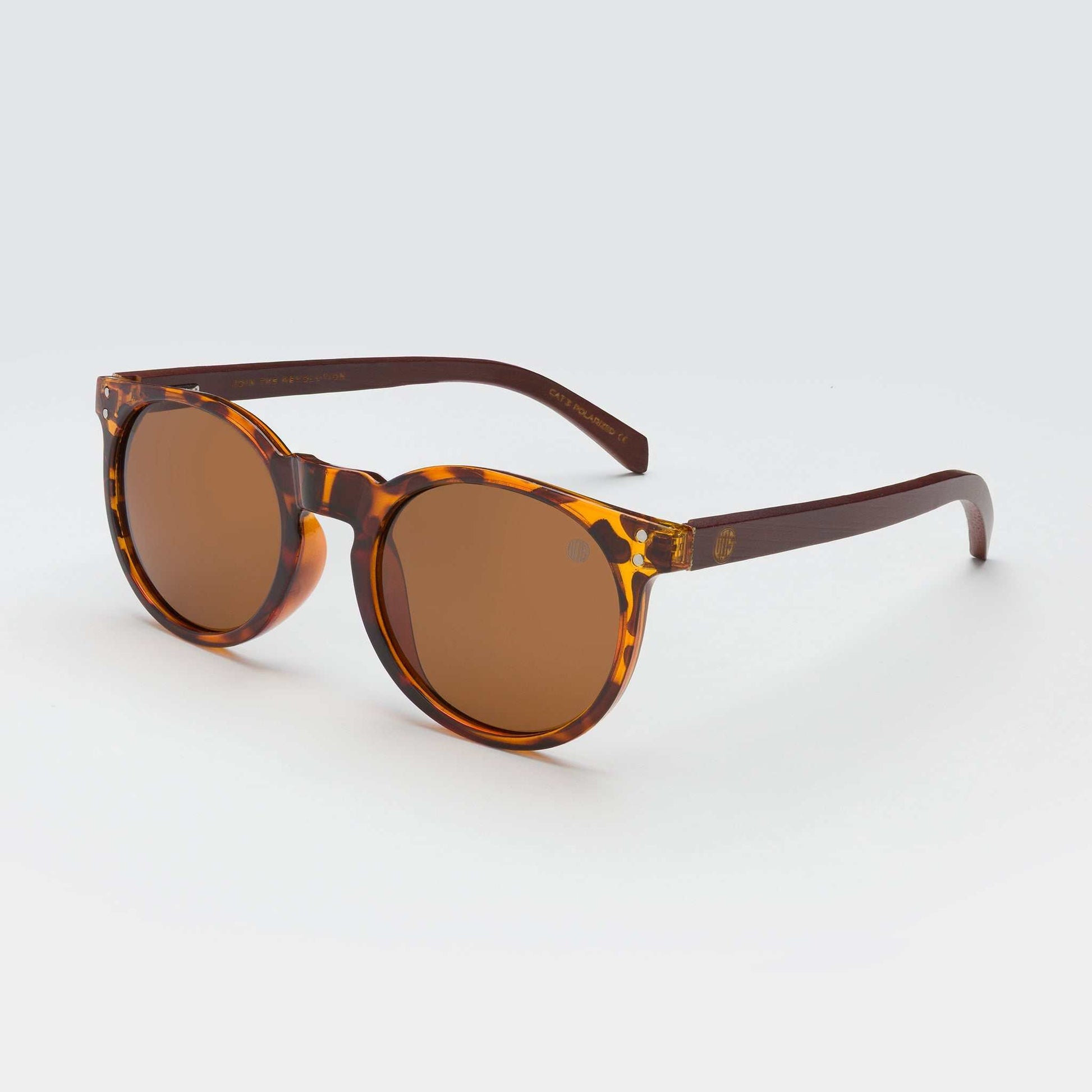 Tortoiseshell round sunglasses with brown lenses and dark slim temples.