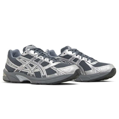 Pair of ASICS GEL-1130 trainers with silver logo stripes and dark mesh quarter panels.