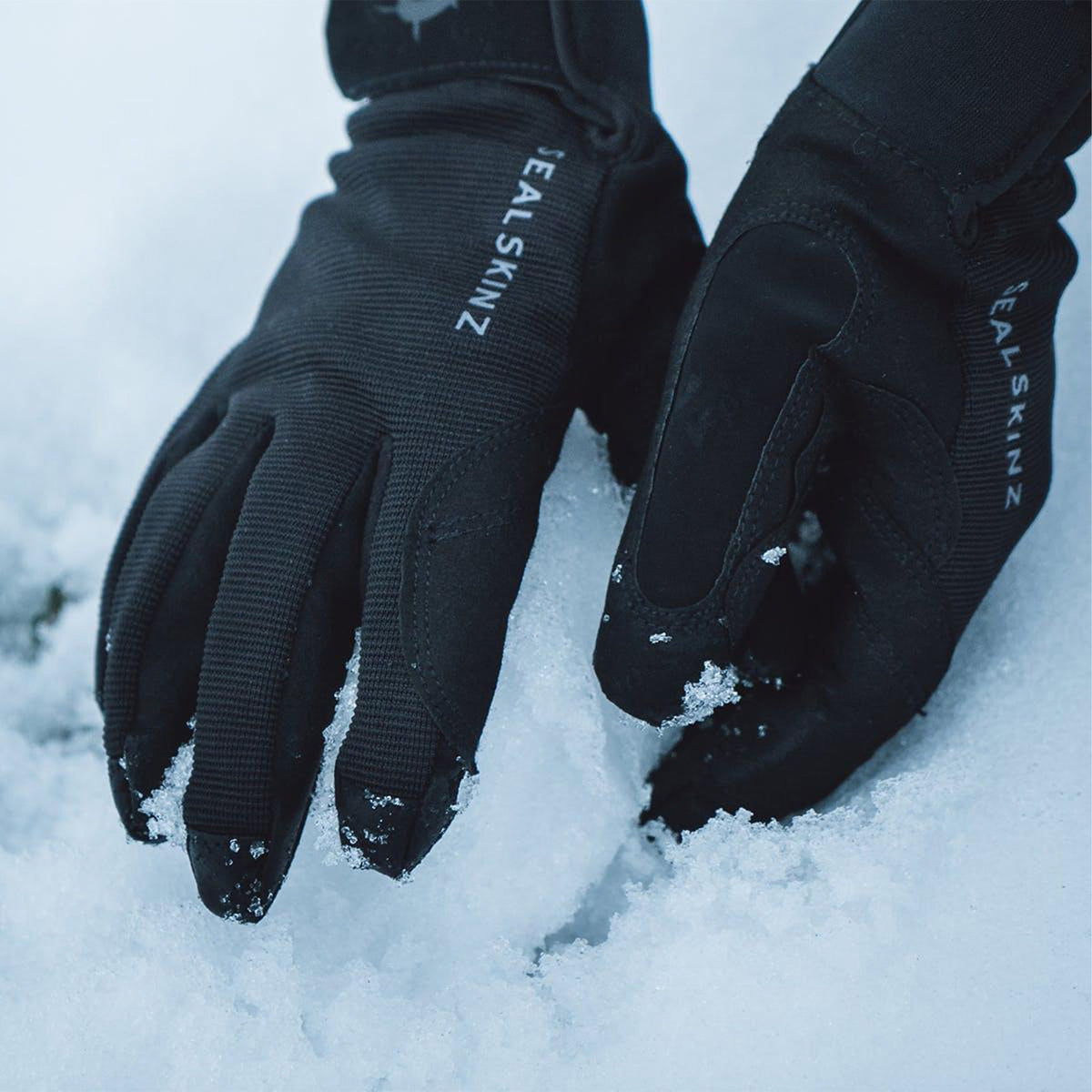 Black gloves with embossed logo on backhand, padded palms and finger seams