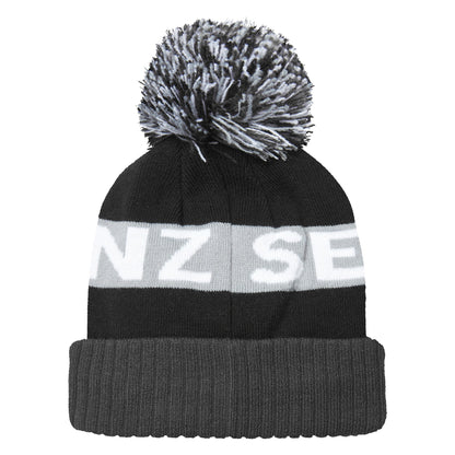 Dark beanie with grey bobble and light stripe reading "NZ SE" plus a leather logo patch