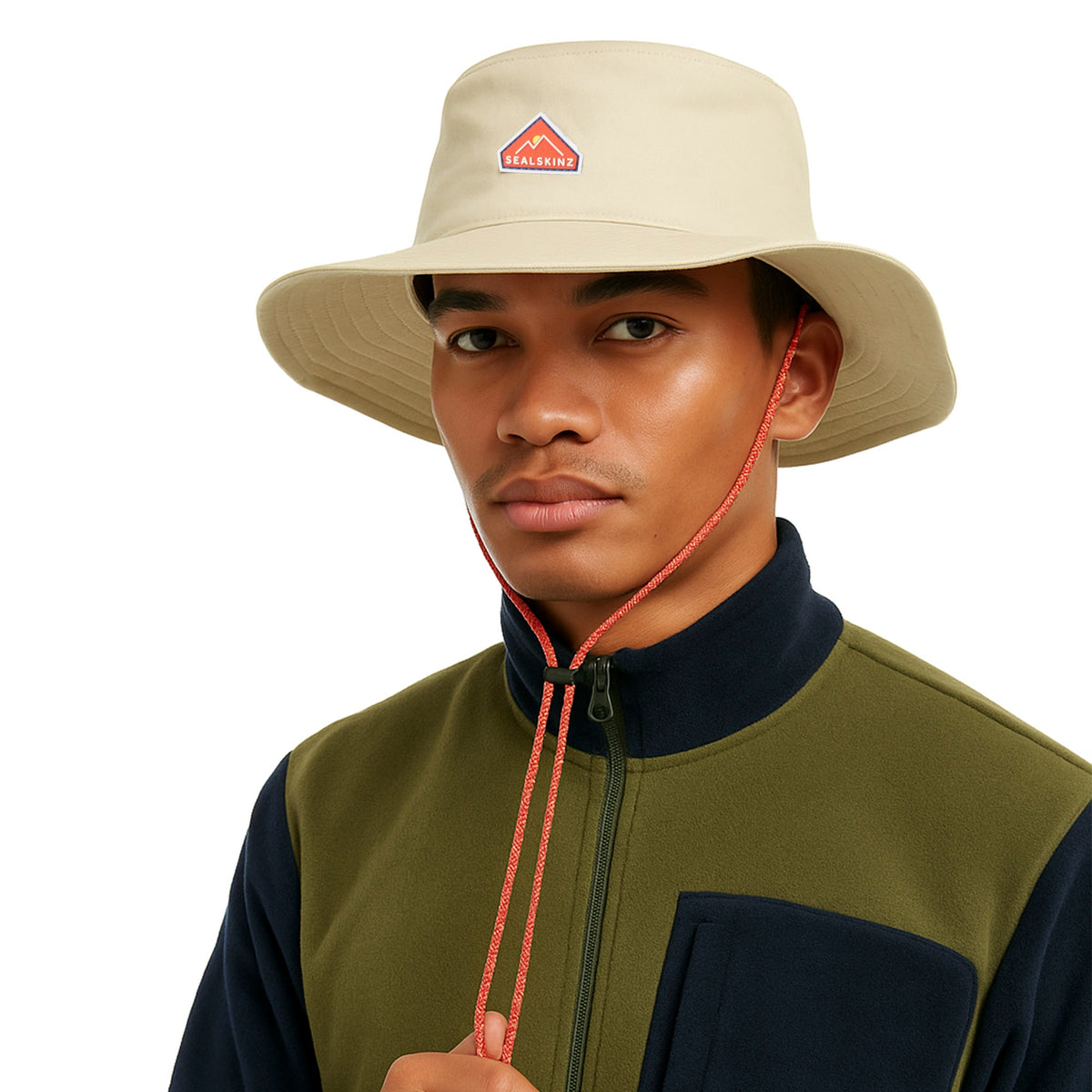 Stone boonie hat worn by model with chin cord and red logo patch, wide brim