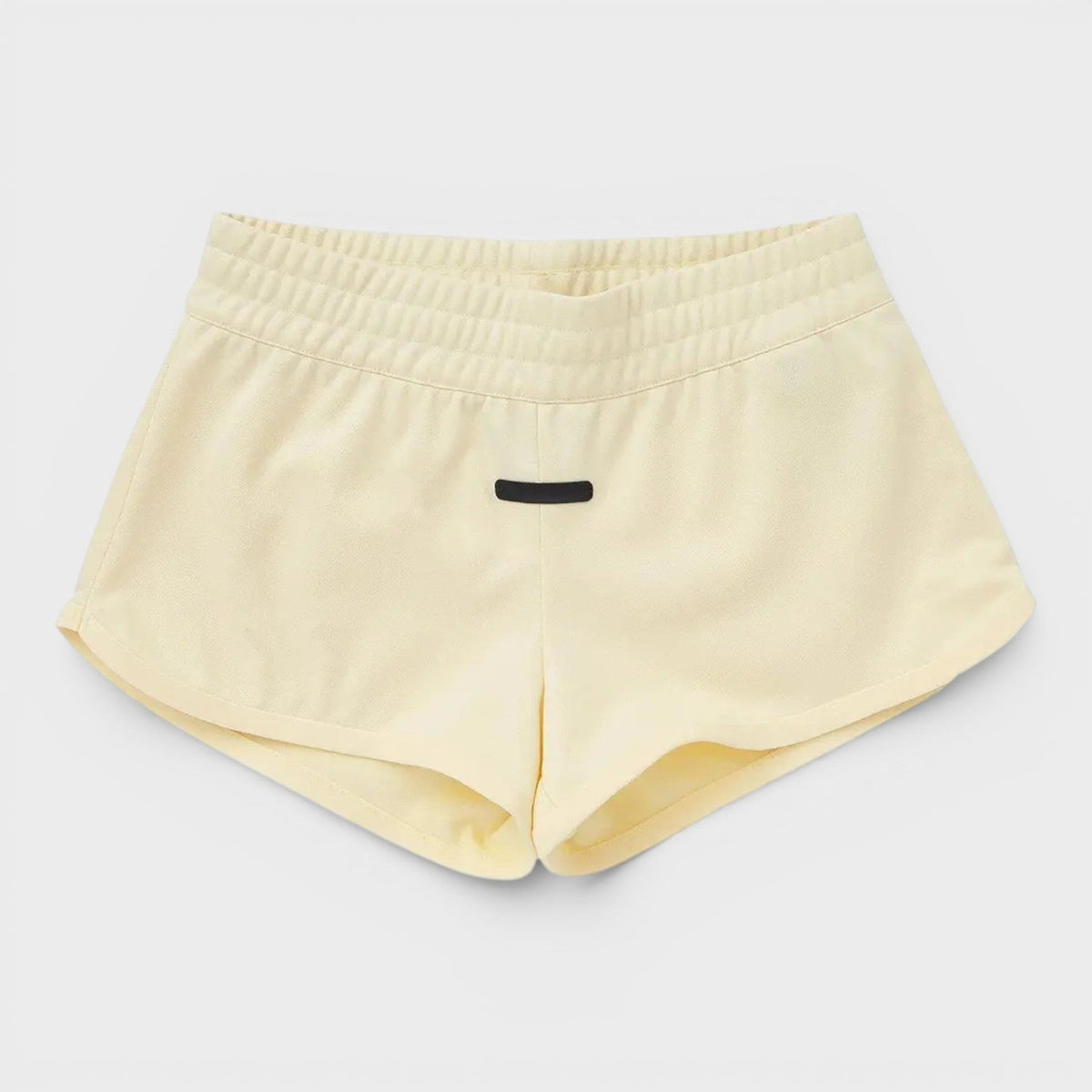 Adidas pale yellow athletic shorts with elastic waistband and small front logo