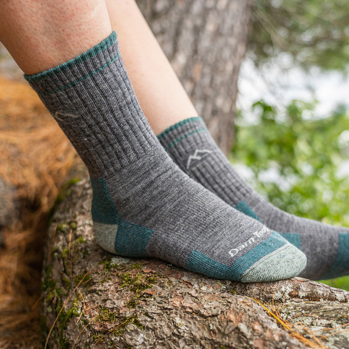 Gray micro crew hiking socks with teal panels and mountain logo