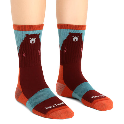 Pair of merino hiking socks in dark brown with coral cuffs and bear graphic