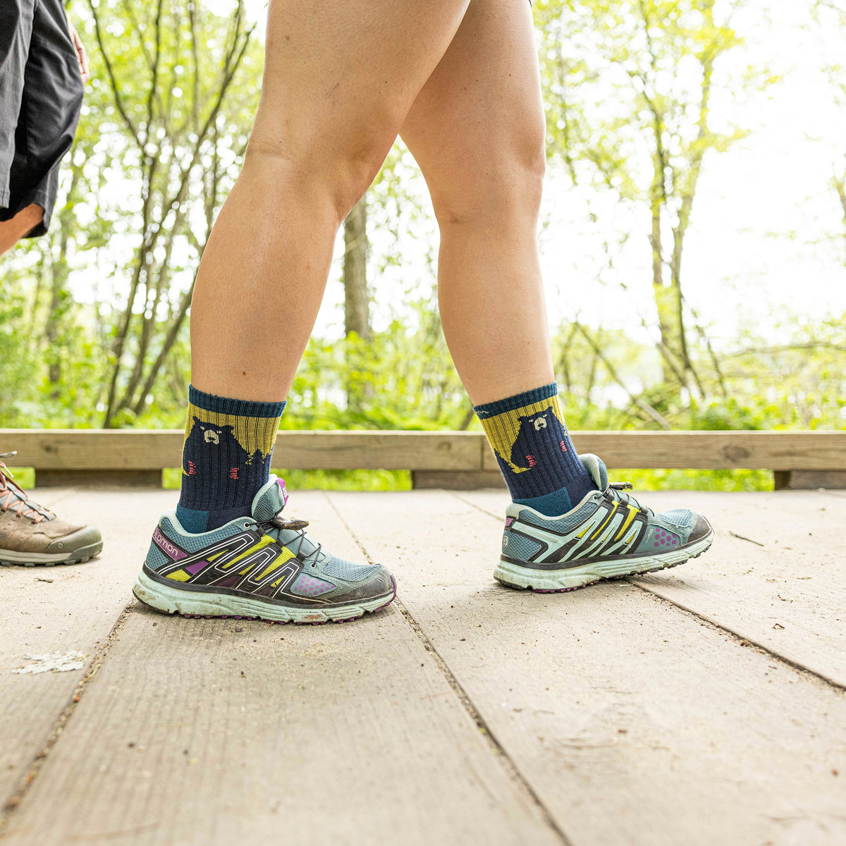 Merino hiking socks in navy with yellow band and bear pattern on the calf