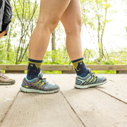 Merino hiking socks in navy with yellow band and bear pattern on the calf