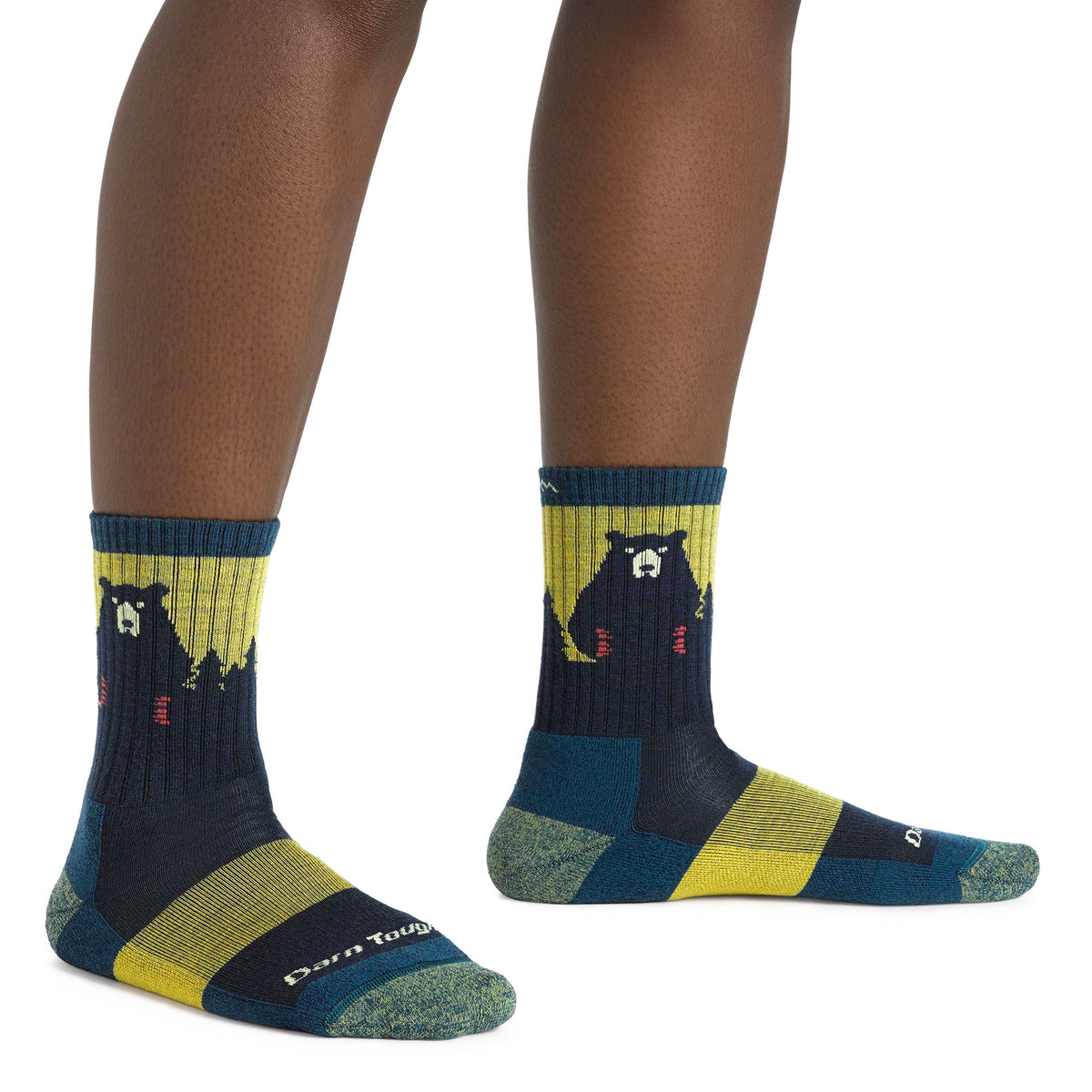 Pair of merino hiking socks in navy with yellow cuffs and bear motif