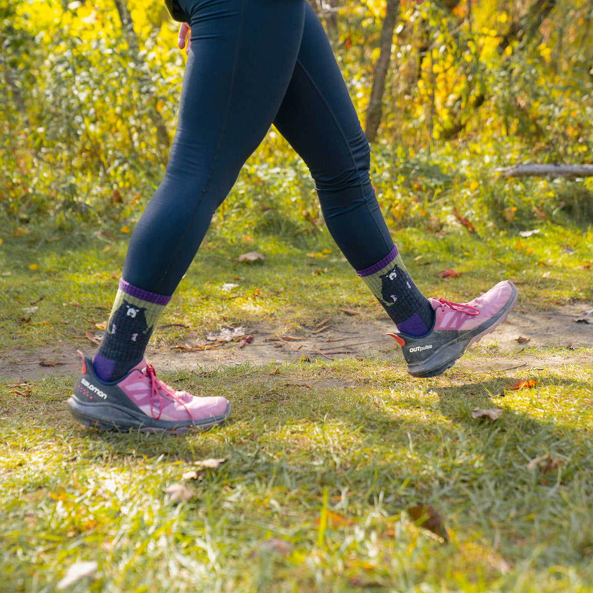 Ladies merino hiking crew socks with navy bear motif, purple bands, and green accents