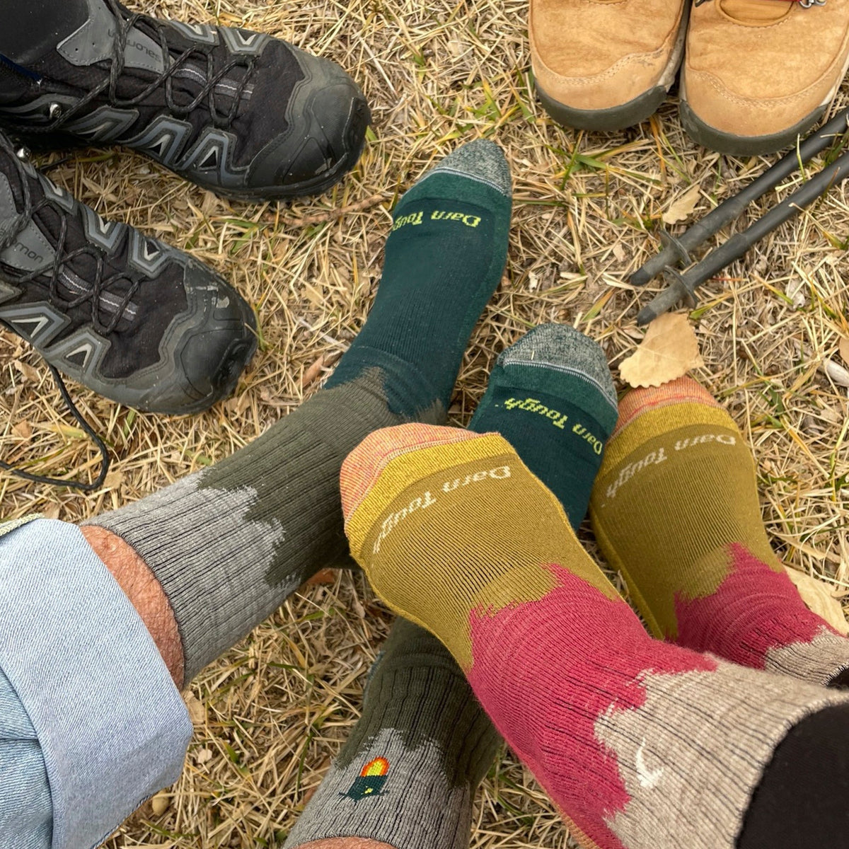 Hiking crew socks with forest patterns in dark green, rust, and charcoal