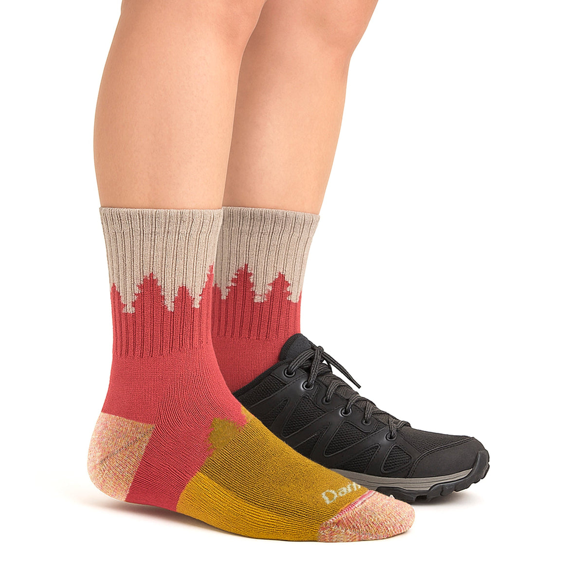 Ladies crew hiking socks in cranberry red and yellow worn with black hiking shoes.