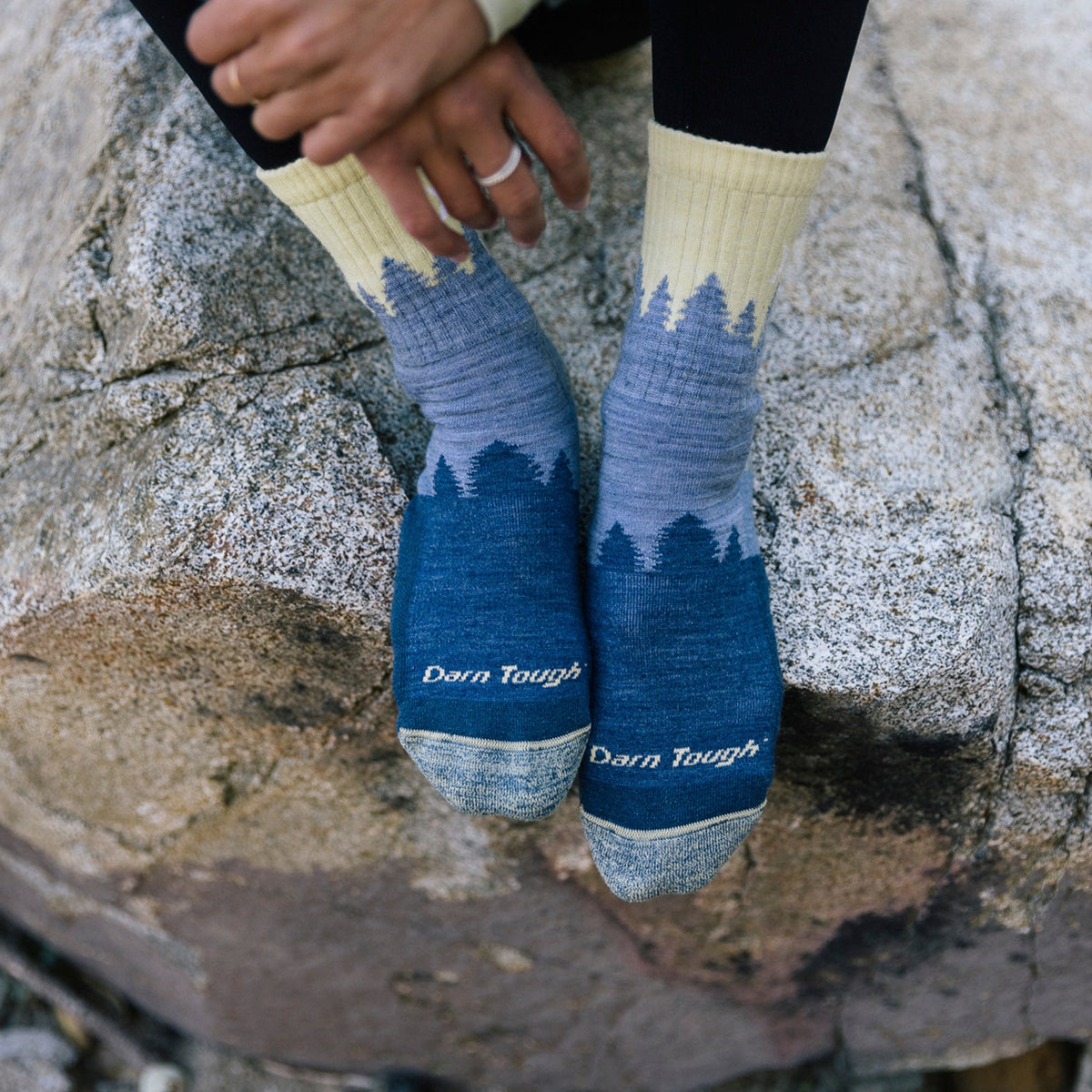 Ladies crew hiking socks in light denim blue with tree graphic and “Darn Tough” text.
