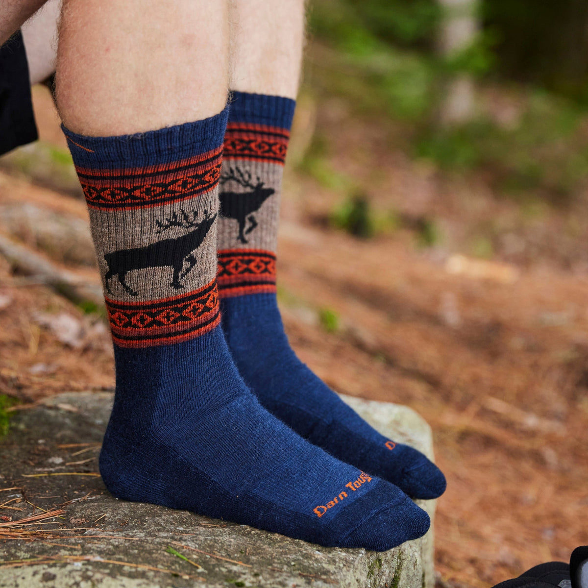Men's merino wool hiking socks, navy base with orange patterned cuff and deer print