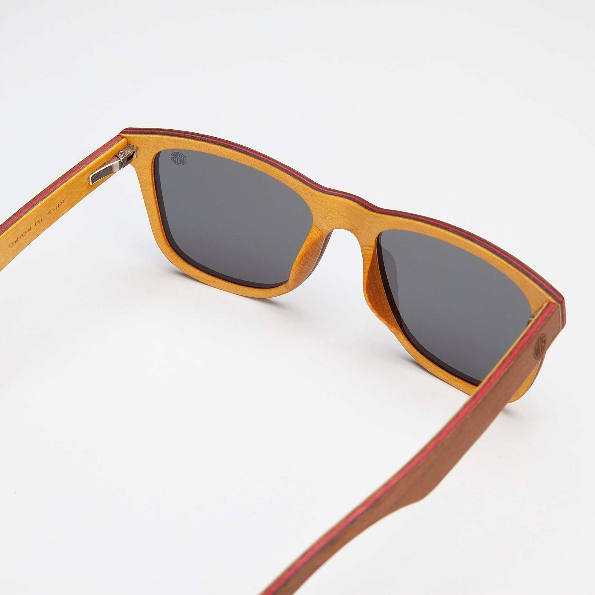 Wood-look sunglasses close-up: orange edge frame with dark gray lenses