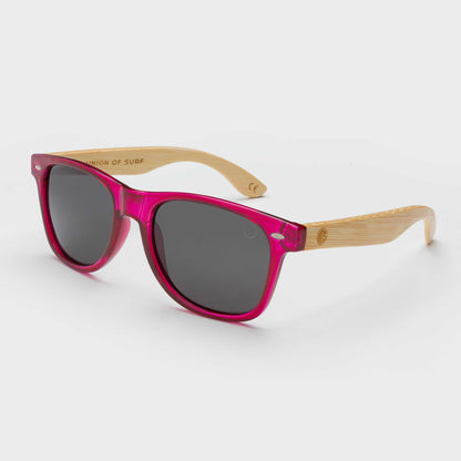 Pink cat-eye sunglasses with dark lenses and bamboo-look arms