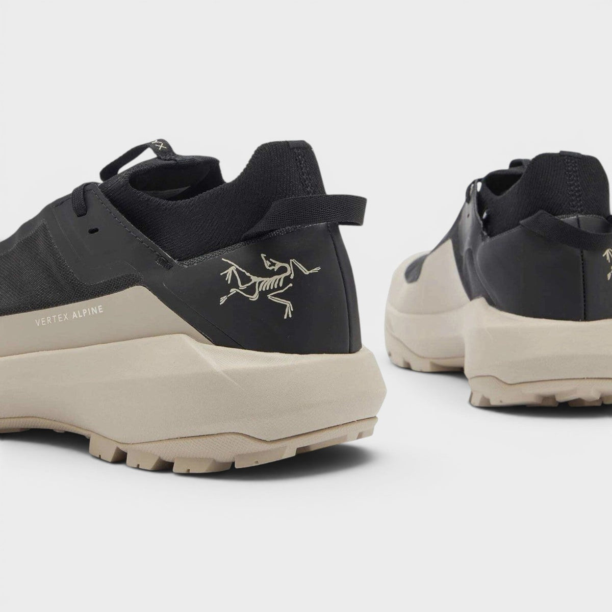 Black lace-up sneakers, side rune graphic and beige midsole, heel view, UK8.5.