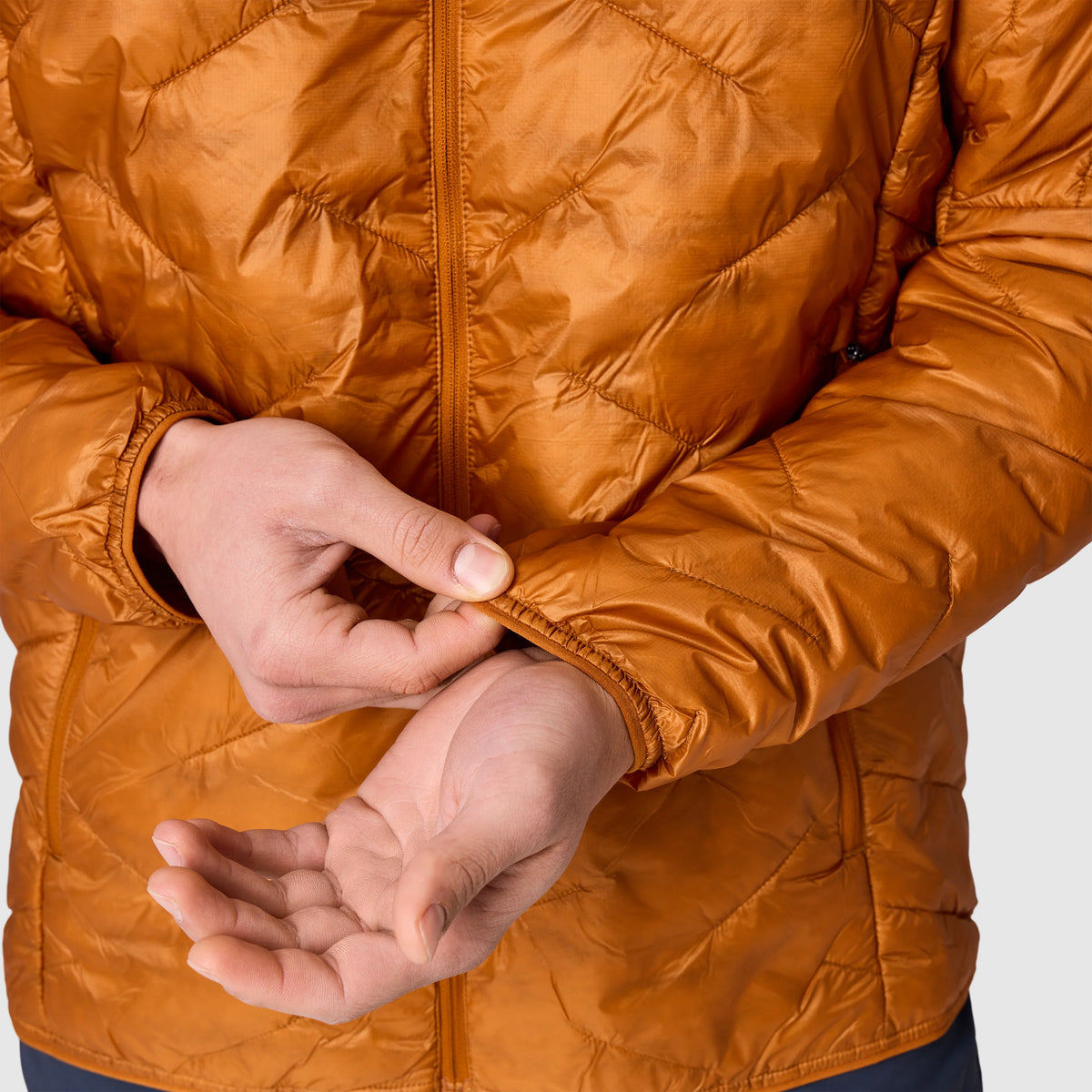 Orange quilted hoodie jacket close-up of zipper front and cuff