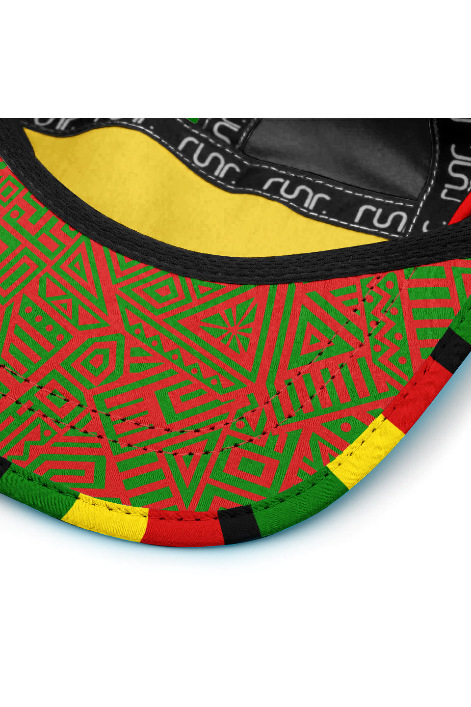 Brim close-up of technical cap with geometric green pattern, black edge, and red trim