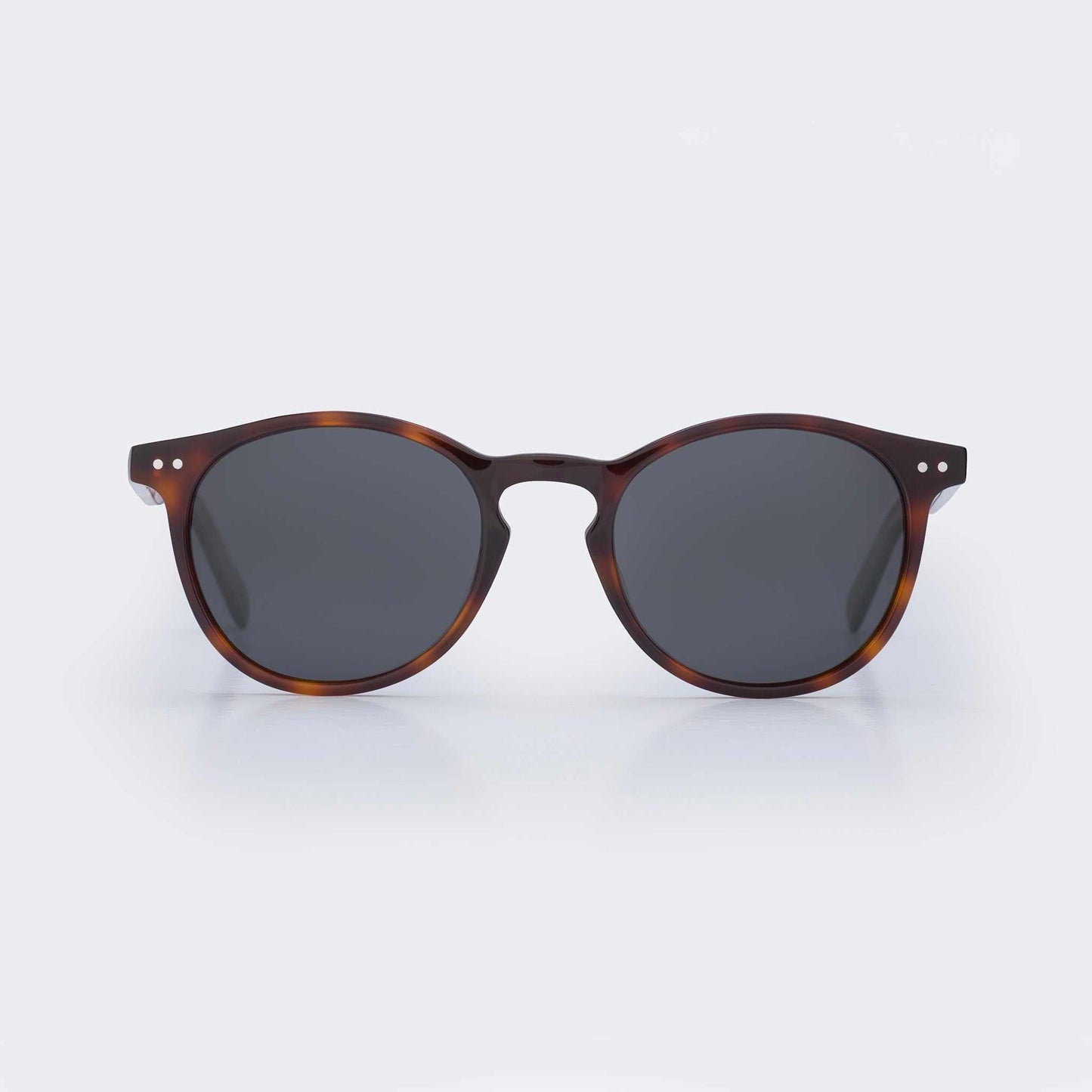 Tortoise shell round sunglasses with dark lenses and bridge keyhole detail