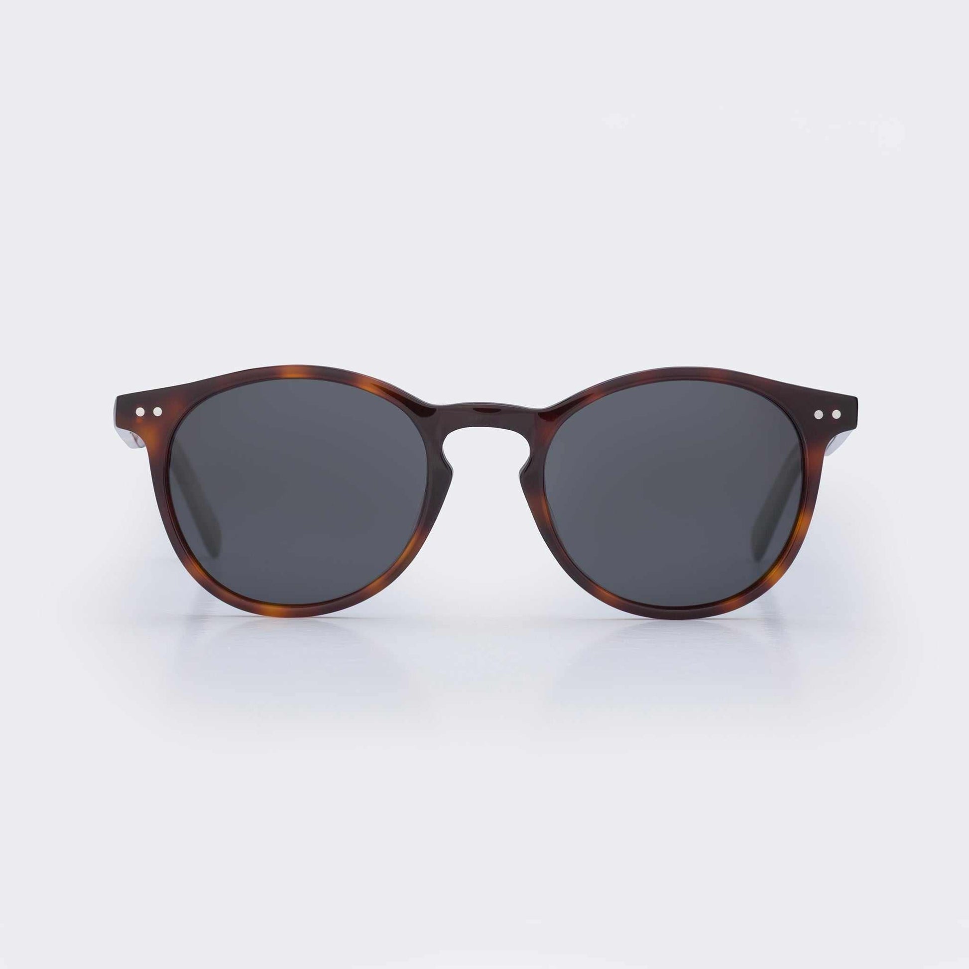 Tortoise shell round sunglasses with dark lenses and bridge keyhole detail