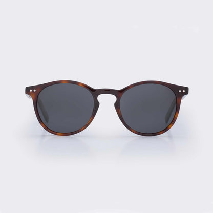 Tortoise shell round sunglasses with dark lenses and bridge keyhole detail
