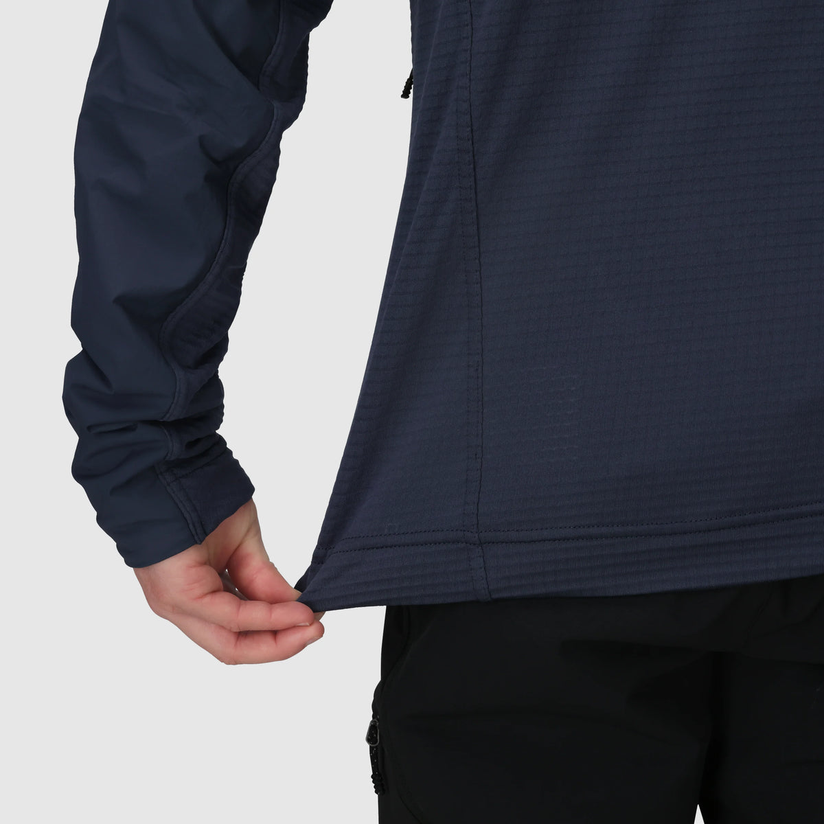 Navy hoodie detail showing a stretch cuff and textured side panel