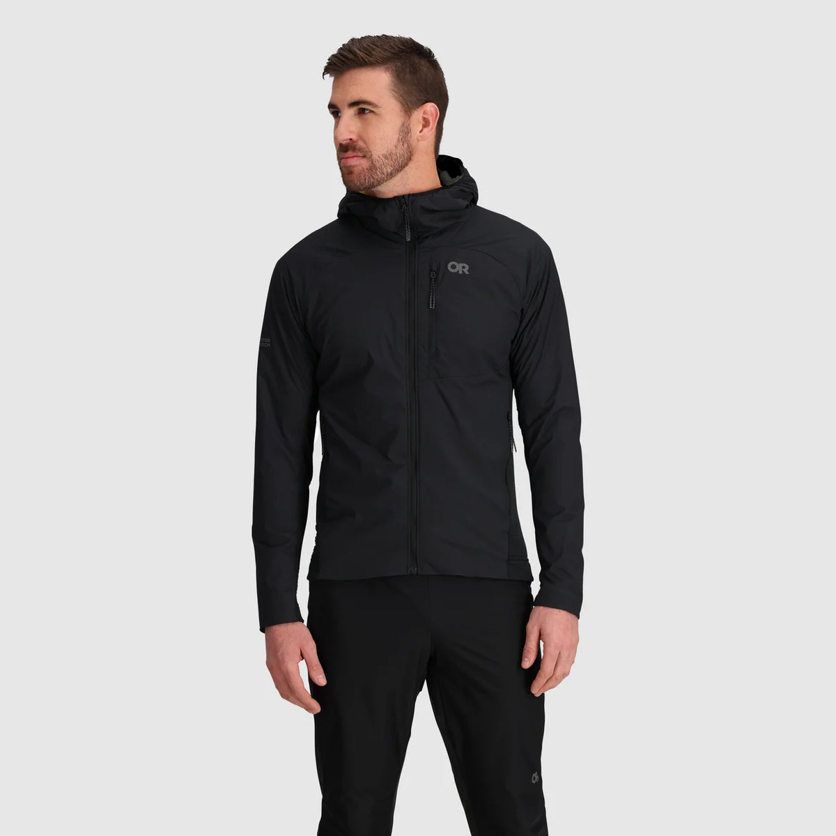 Man wearing a black full-zip hoodie with chest and side pockets
