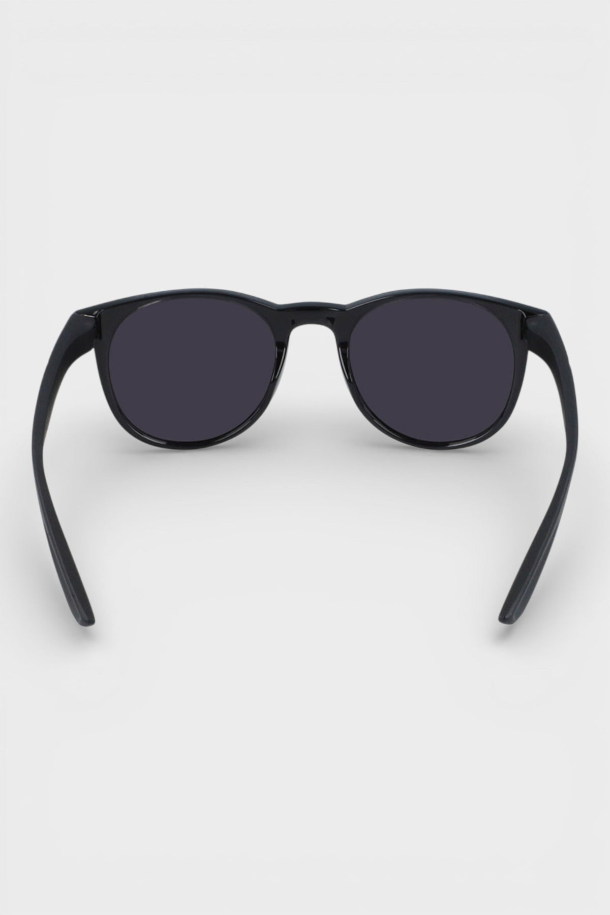 Nike sunglasses with dark lenses and black frame, side view