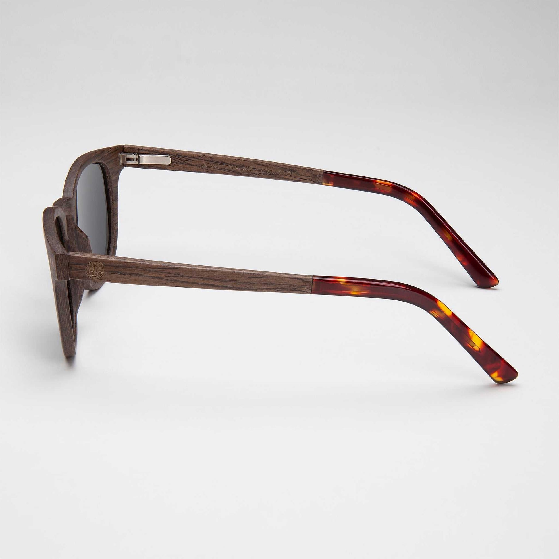 Walnut-framed sunglasses with dark lenses and tortoise temple tips