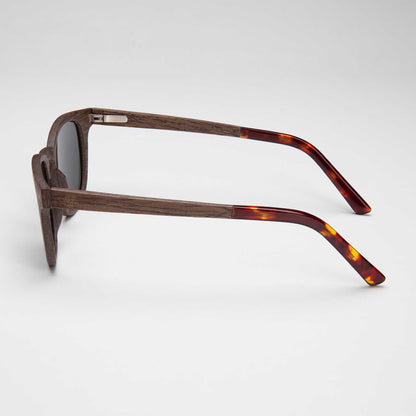 Walnut-framed sunglasses with dark lenses and tortoise temple tips