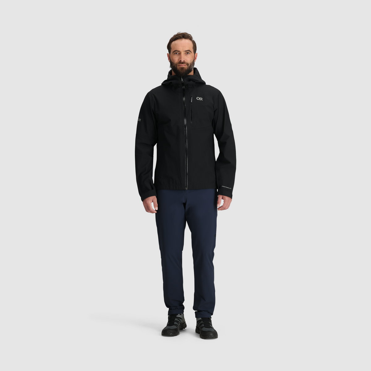 Black 3L waterproof hooded jacket with full-zip front, worn with navy pants