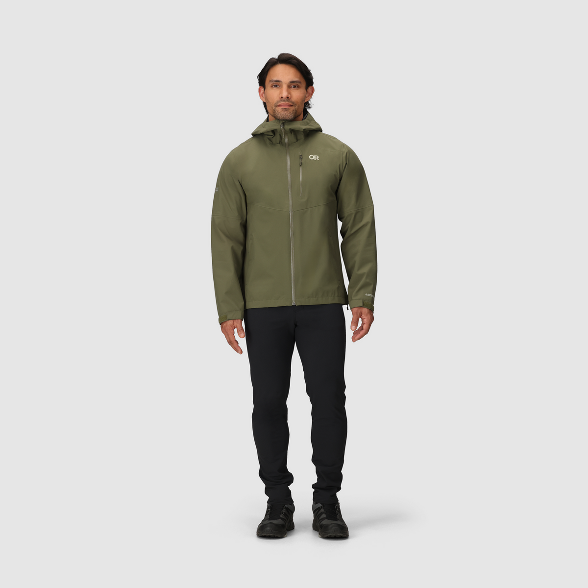Olive green 3L waterproof hooded jacket with full-zip front, worn with dark pants
