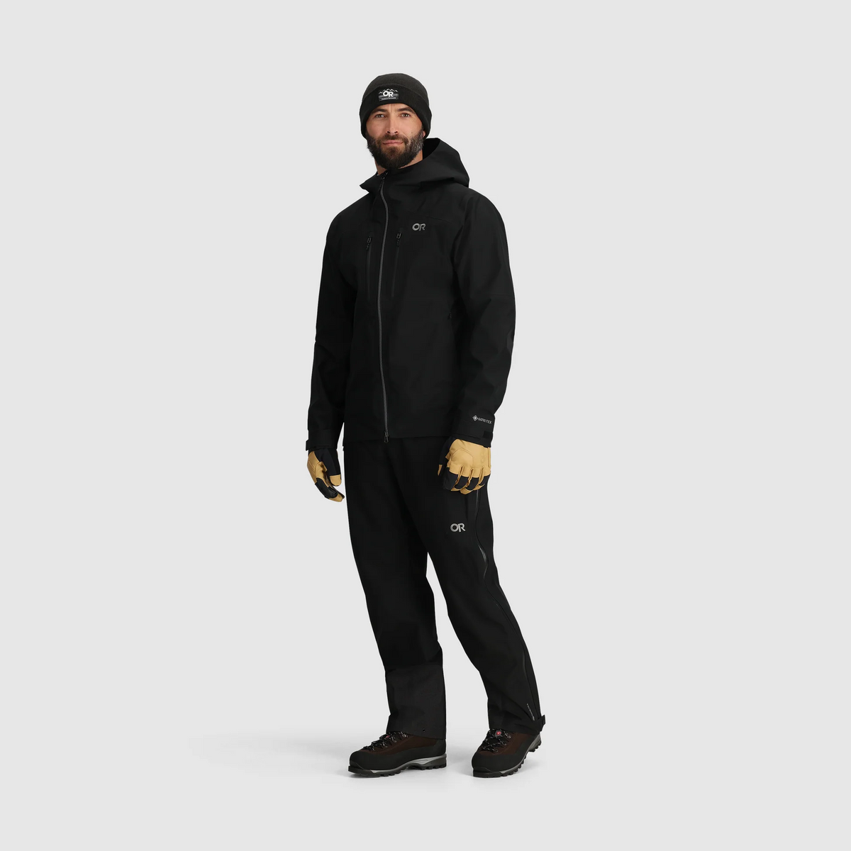 Men's black GORE-TEX 3L jacket with hood, zip front, and adjustable hem