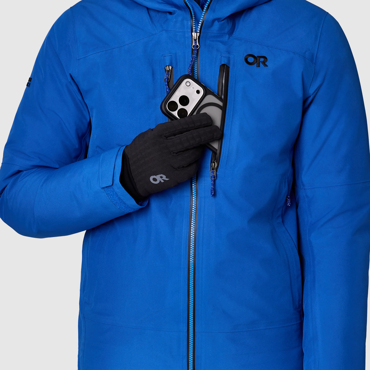 Men's blue jacket detail with two-way zipper and OR logo on chest