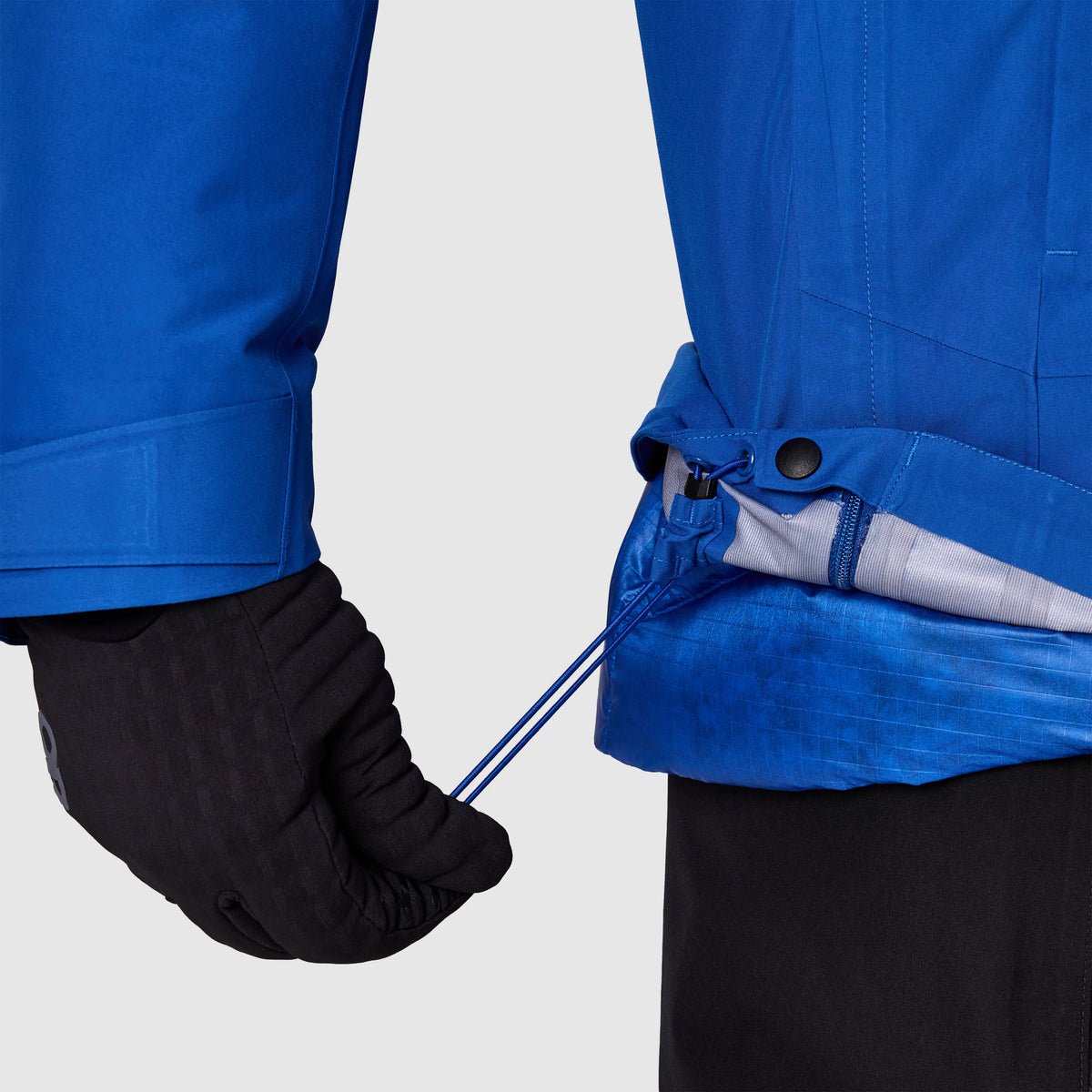 Men's blue jacket with cinch strap at waist and black glove cuffs